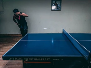 an old racket with a table tennis ball